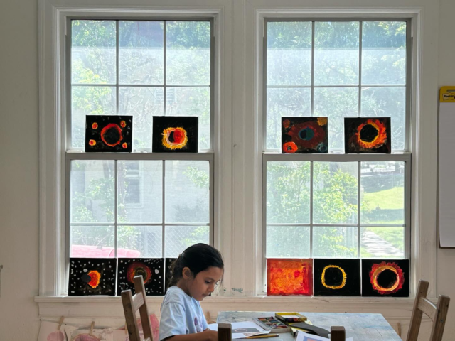 Our atelier this week! Our students’ pieces inspired by @rohinidevasher were placed in the windows. It was a beautiful sight to see how the canvases were illuminated by the sun and really gave the understanding of what happens during an eclipse. #projectbasedlearning